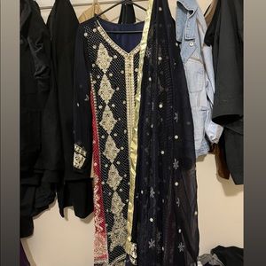 A long designed Black and Blue shalwar Kameez. Size is XL and Material is Pure.